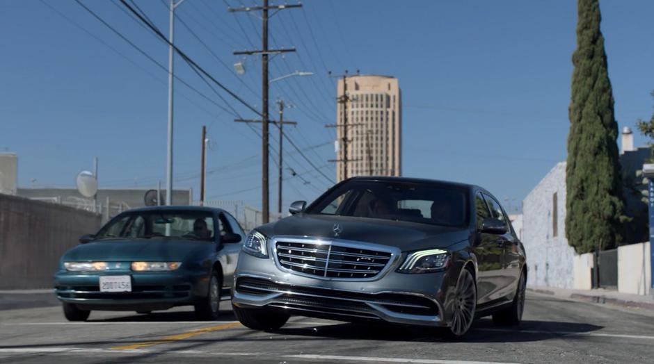 Catherine and Geoffrey make a sharp turn in front of another car to follow Alex.