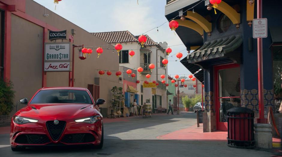 Alex pulls the stolen car to a stop in the middle of Chinatown while his parents turn the corner at the other end of the block.