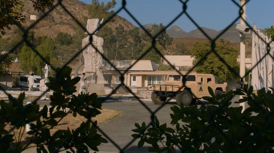 Heavy security patrols the compound within the barbed-wire fence.