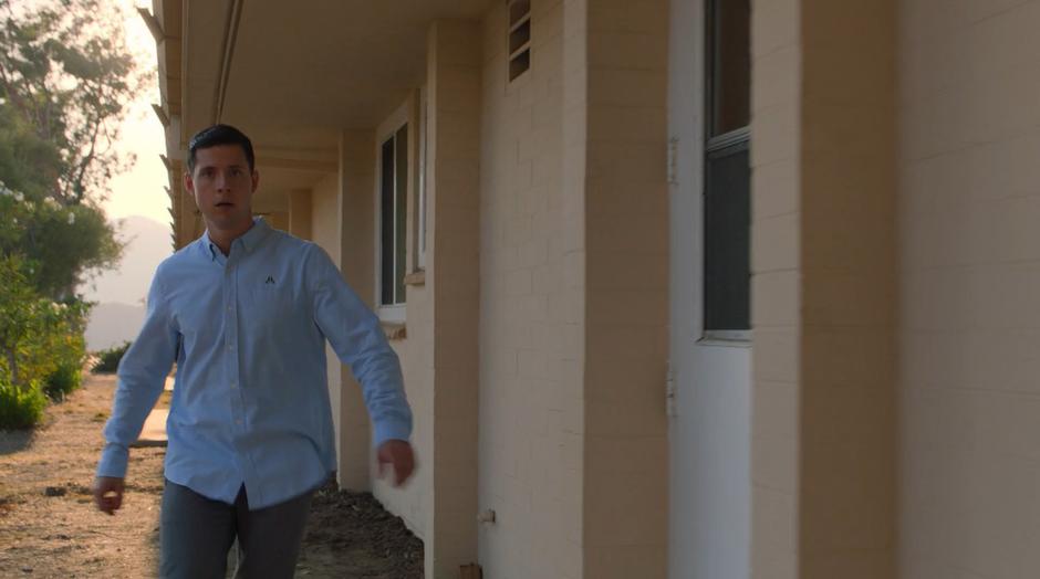 Vaughn sneaks around the outside of one of the buildings after scouting around.