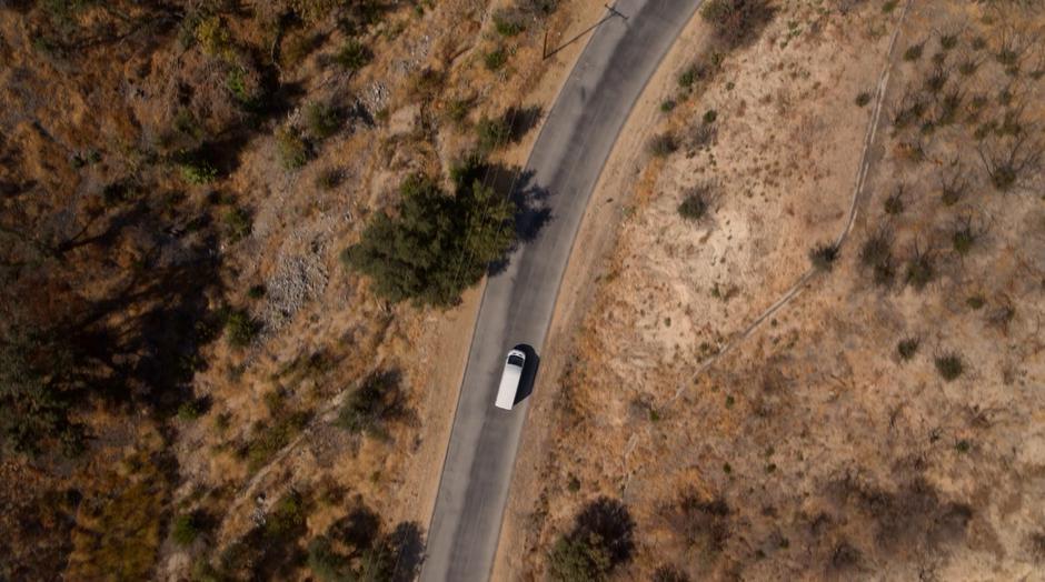 The Church of Gibborim van drives down a winding desert road.