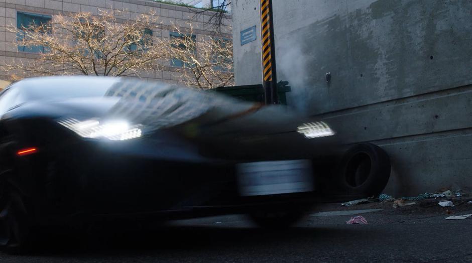 The stolen car enters the alley after turning off the street.