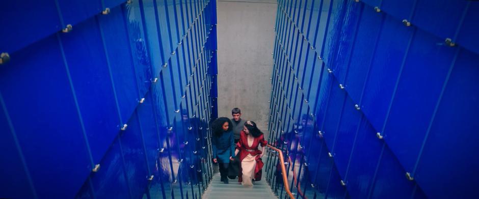 Young Michael, Amanda, and Sarek walk up the stairs towards Spock's bedroom.