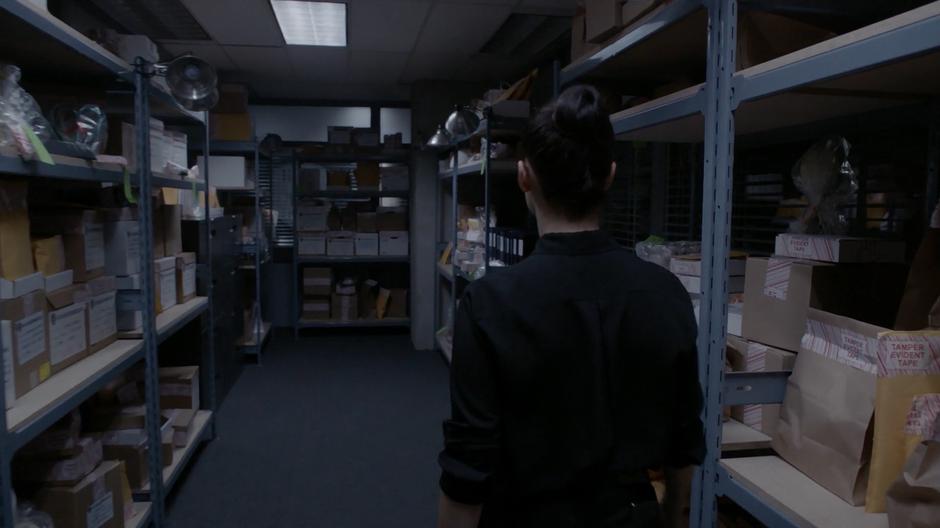 Kady searches through the evidence room for what she needs.