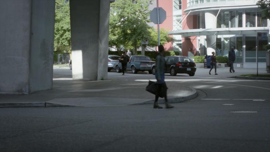 Mark runs across the street away from his car.