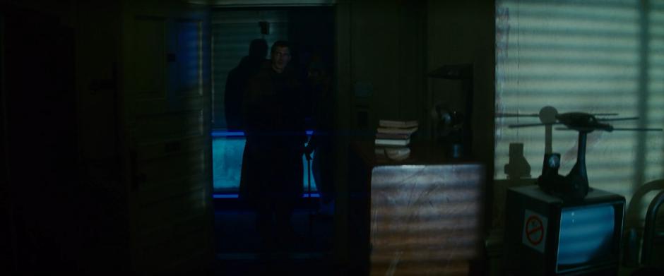 Deckard and Gaff enter the hotel room.