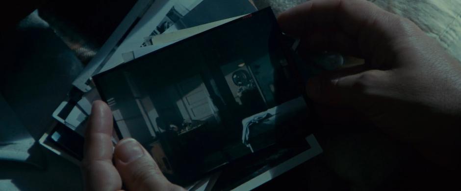 Deckard examines a photograph he found in the dresser.