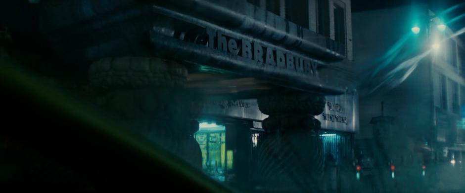 The name of the building is visible through Deckard's windshield.