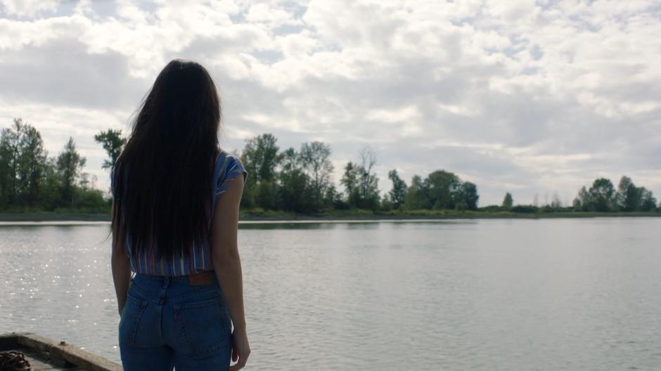 Ryn stares out over the water from the dock.