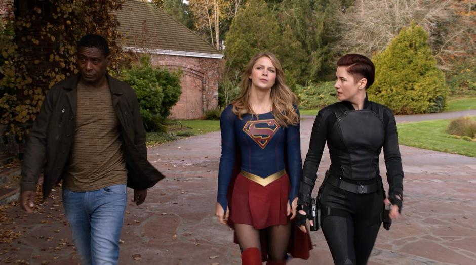 J'onn, Kara, and Alex walk down the driveway looking for General Tan.