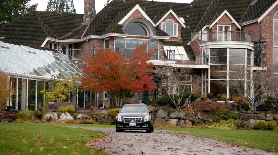 General Tan drives his car away from his mansion.