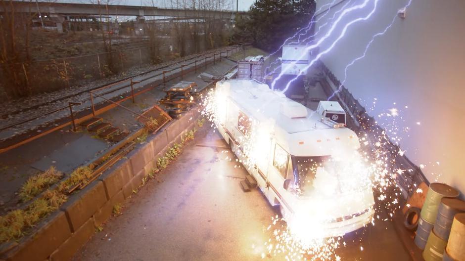 Sparks explode from the RV as it is hit by lightning.