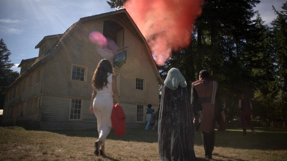 Margo, Fen, and Tick walk towards the barn as a cloud of dust flies into the air.