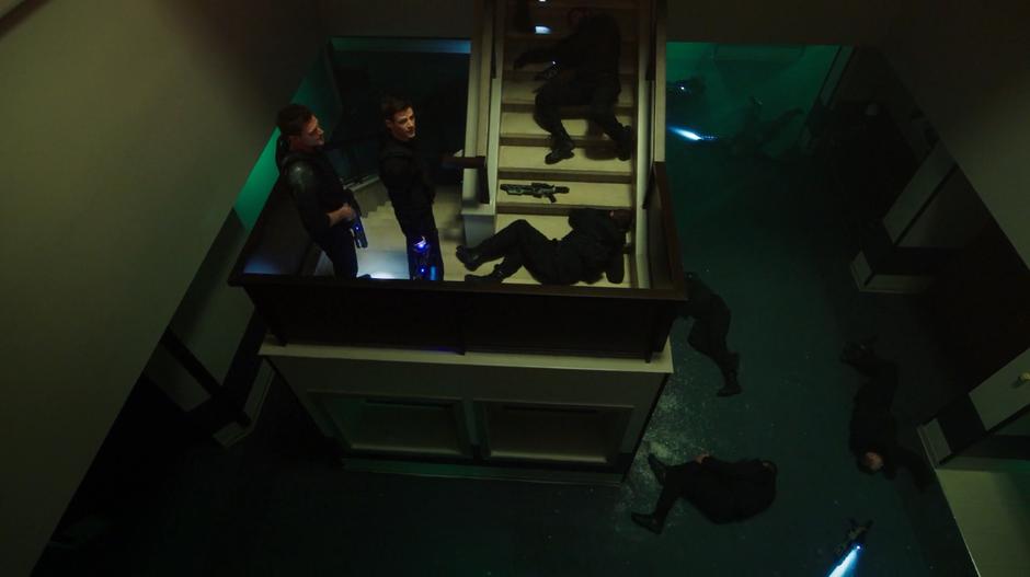 Ralph and Barry stand on the stairs surrounded by the unconscious bodies of all of the goons.