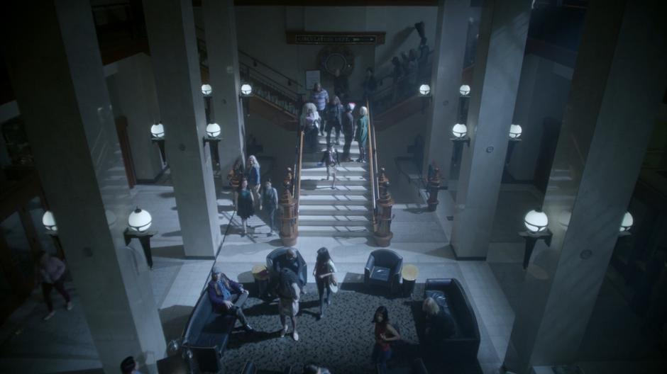 Penny and Kady stand on the stairs as the people who were in line run outside to get free ice cream.