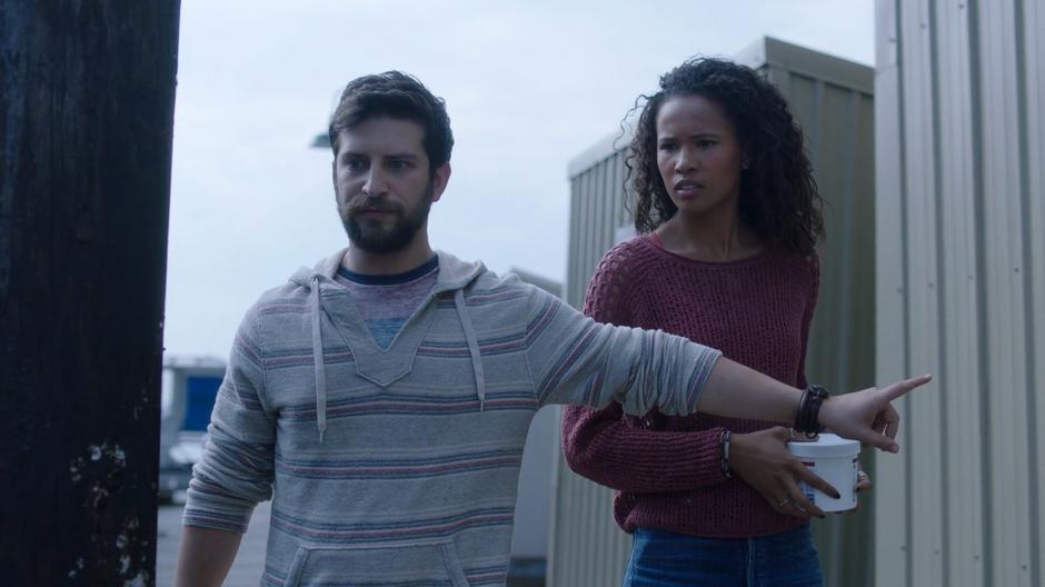 Jerry holds out his arm to stop Maddie from going near the rat on the dock.