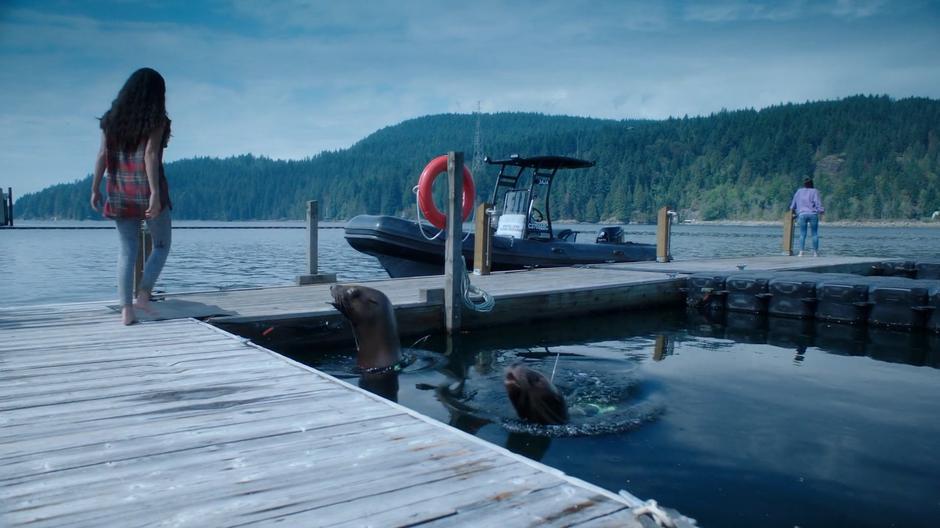 Katrina walks over to Ryn as she is standing on the end of the dock in a weakened state.