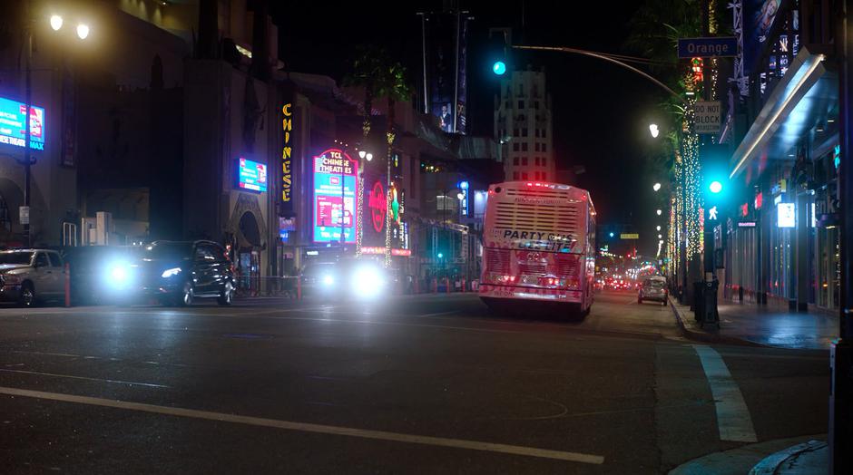 The party drives across the intersection and off down Hollywood Boulevard.