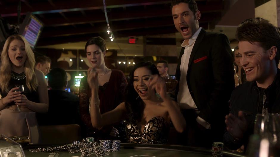 Ella and Lucifer yell after Ella wins a hand at blackjack.