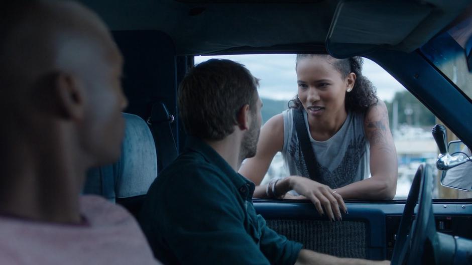 Levi watches as Maddie leans in Ben driver's side window talking to him.