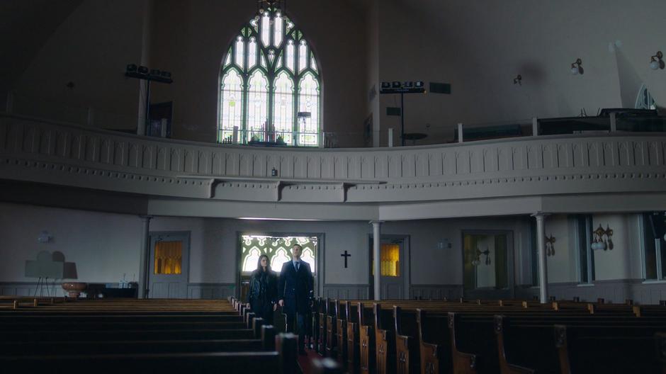 Mel and Harry look around inside the church.