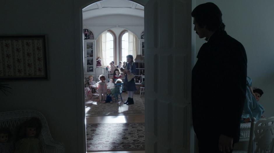 Ray peeks into the little girl's room as she talks to her dolls.