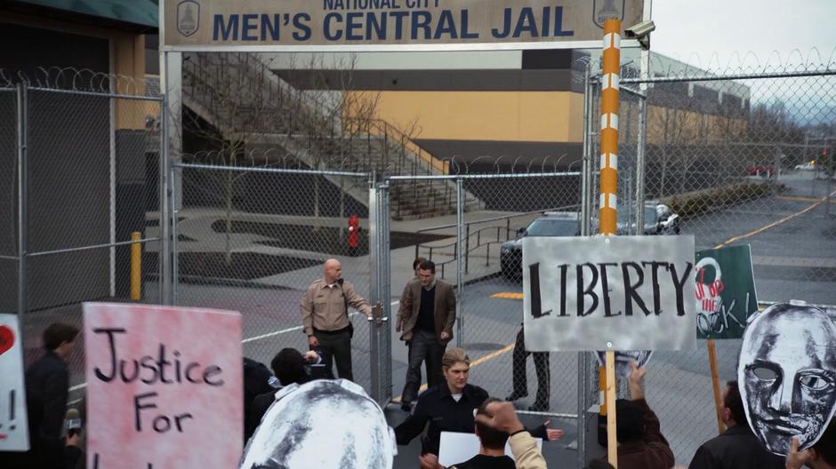 Ben Lockwood is let through the prison gate to where a crowd of protesters are waiting.