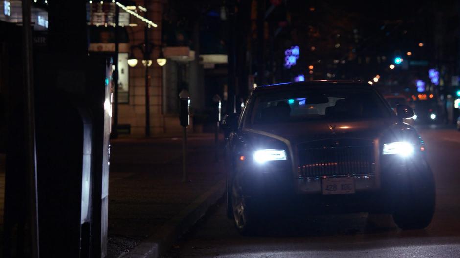 Lena's towncar pulls away from the curb.