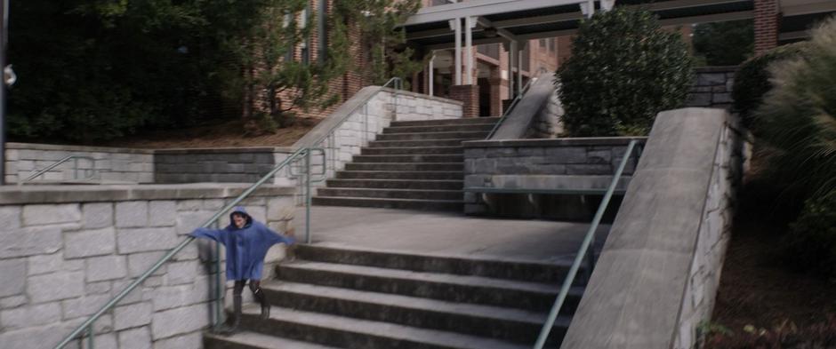 Tiny Scott runs down the stairs towards the street.