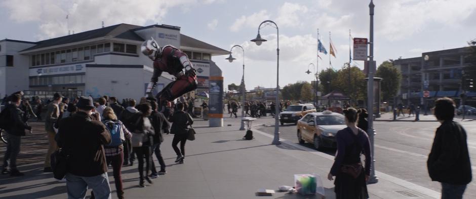 A enlarged Scott tries to clear a path through the crowd at the pier.