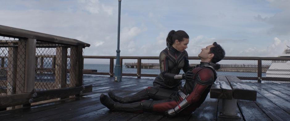 Hope sets Scott down on the pier after rescuing him from the water.