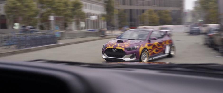 Luis drives past the pursuing SUV in his fancy new car.