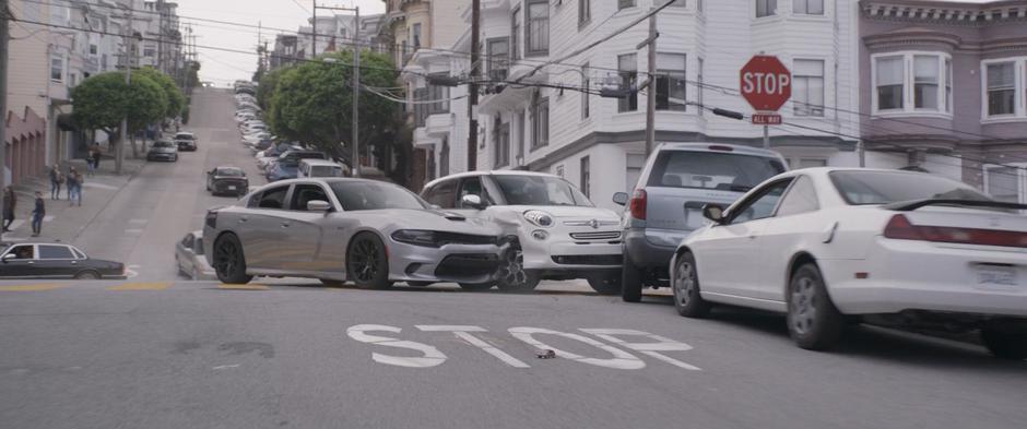 One of the pursuing cars crashes into another car.