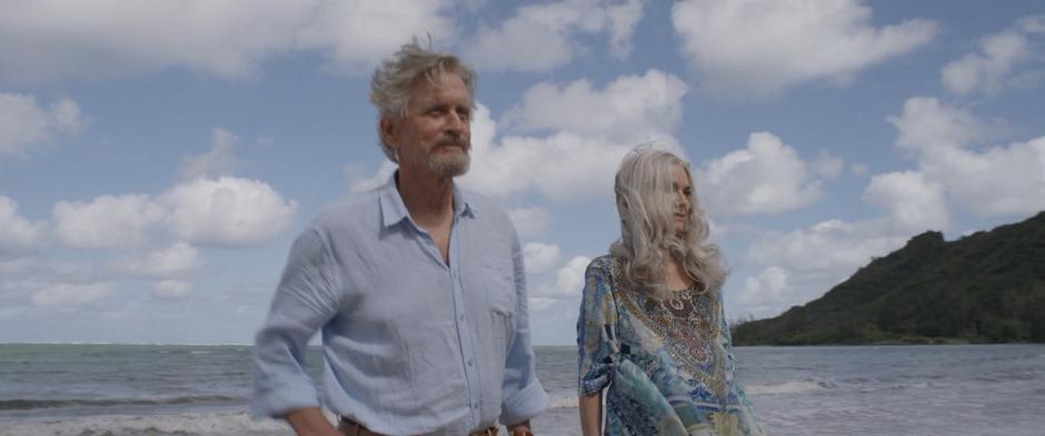 Hank and Janet watch as their house enlarges to full side on the edge of the beach.