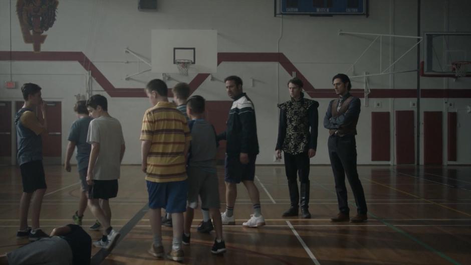 Charlton and Eliot watch as the gym teacher breaks up the attack on Taylor.