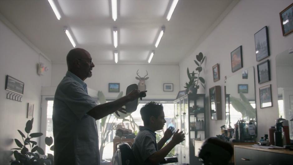 The barber shows young Eliot his terrible haircut.