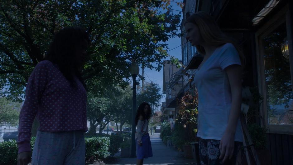 Viv and Eliza share a look as Cami turns around and heads off down the sidewalk.