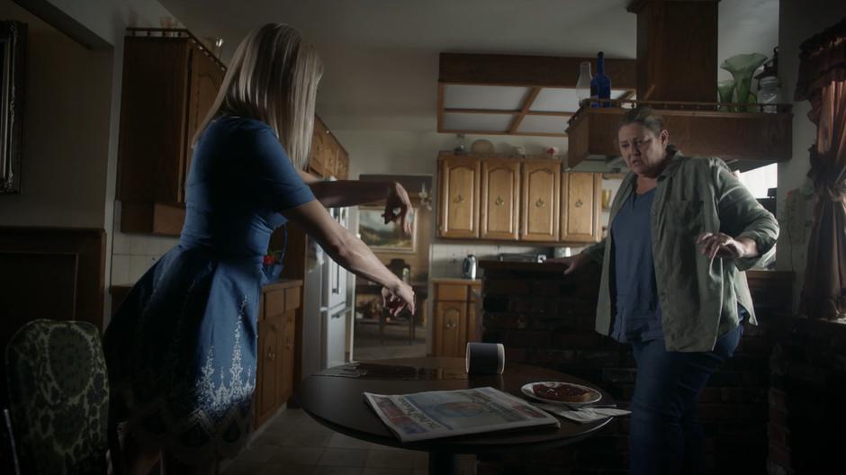 Shelia jumps back as Alice casts a spell to clean up the spilled coffee.