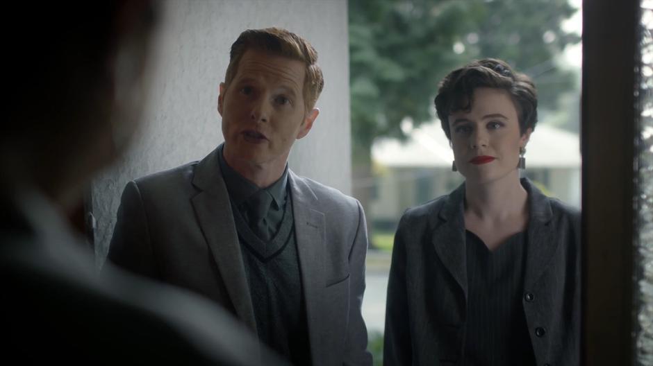 Two librarians talk to Shelia at her front door.