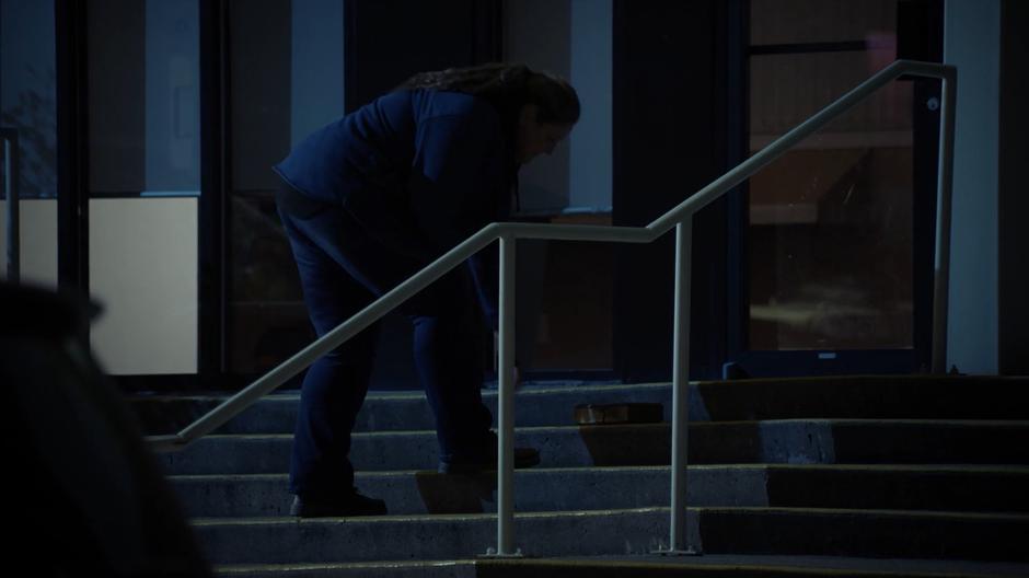 Shelia sets down the box of money on the steps of the church.