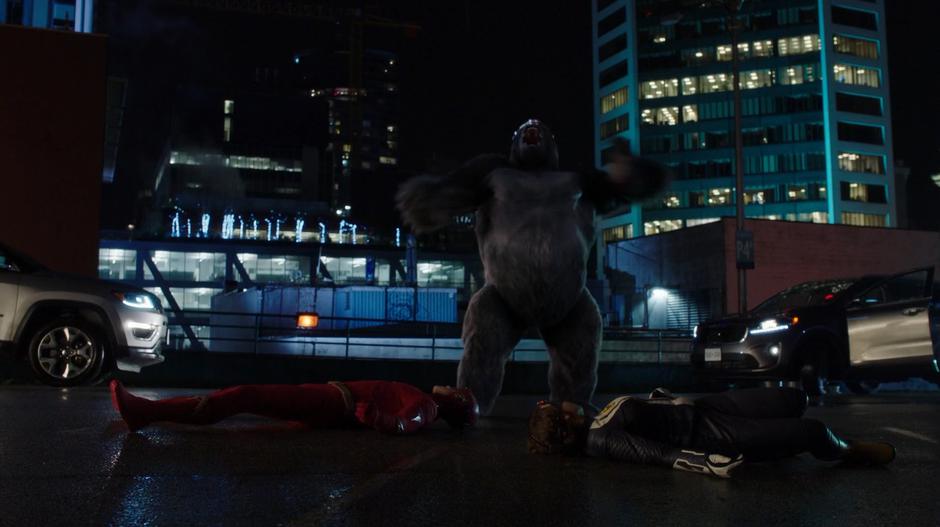 Grodd roars while standing over the prone bodies of Barry and Nora.