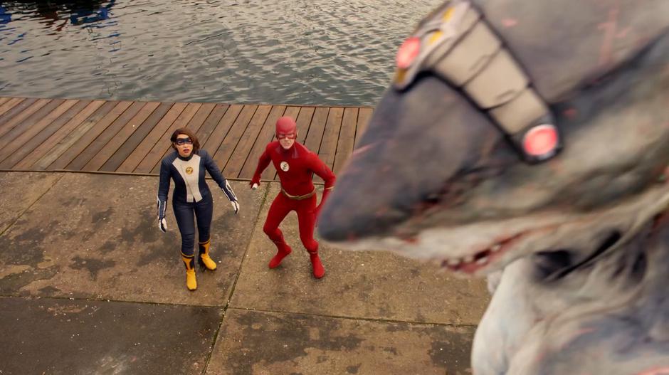 Nora and Barry stare up at King Shark as he attacks Cisco.