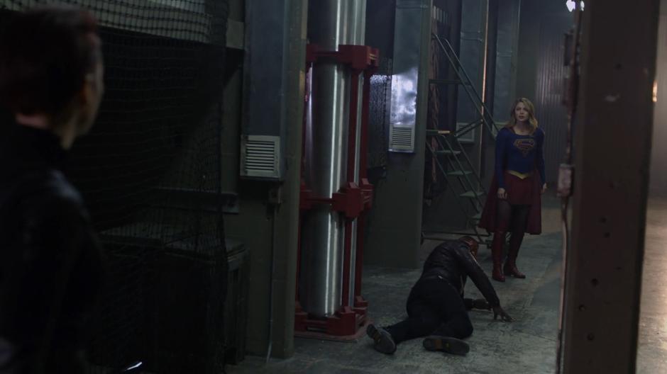 Kara looks over at Alex while J'onn climbs back to his feet.