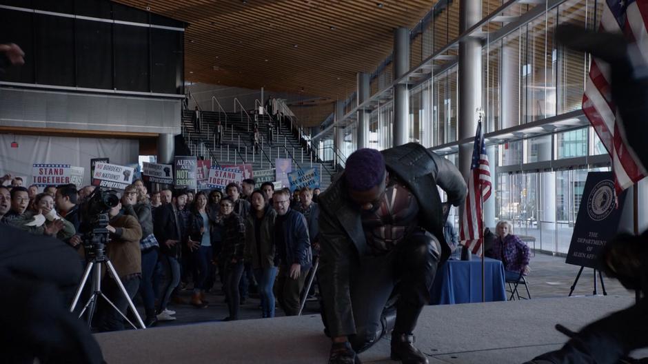 People jump back as Manchester lands on the stage while his duplicates stand at the back on the stairs.