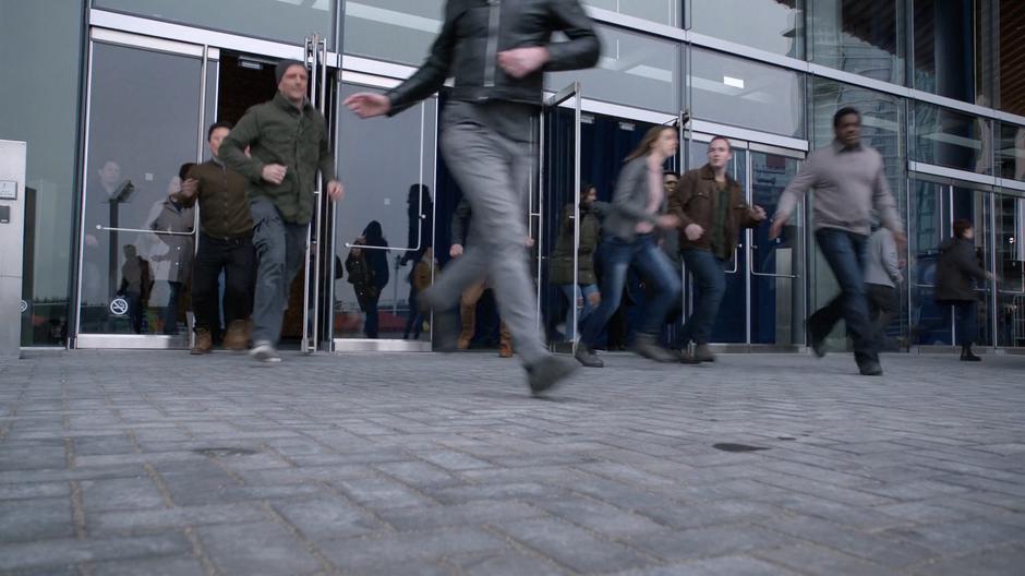 People run from the building as the fight breaks out.