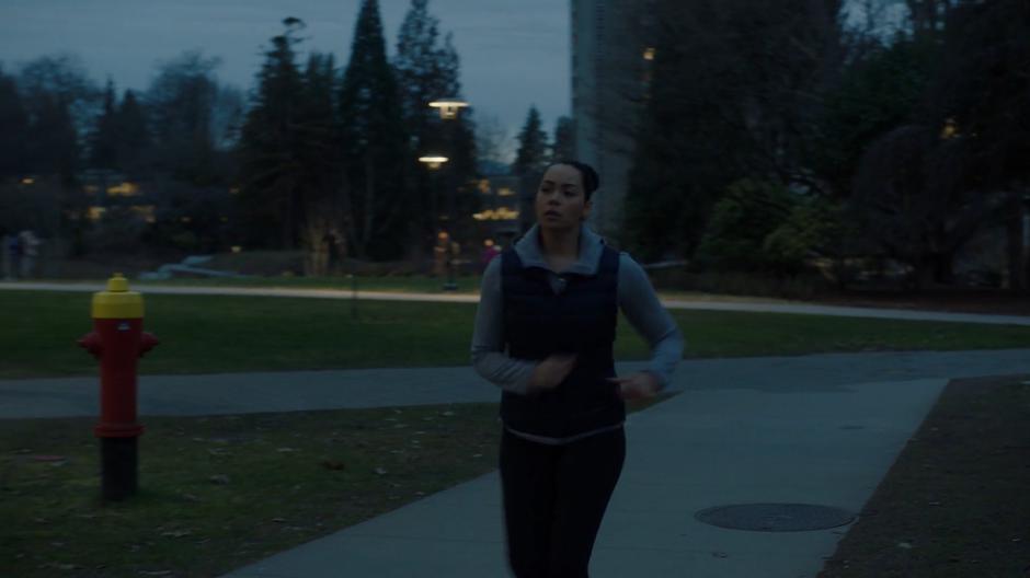 Macy jogs down the path in the early morning light.