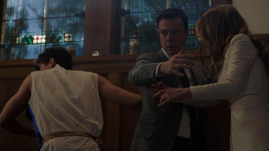 Parker, Harry, and Charity look around on the stairs after being transformed back from stone.