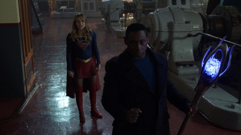 Kara lands behind J'onn after saving the dam and asks about Manchester.