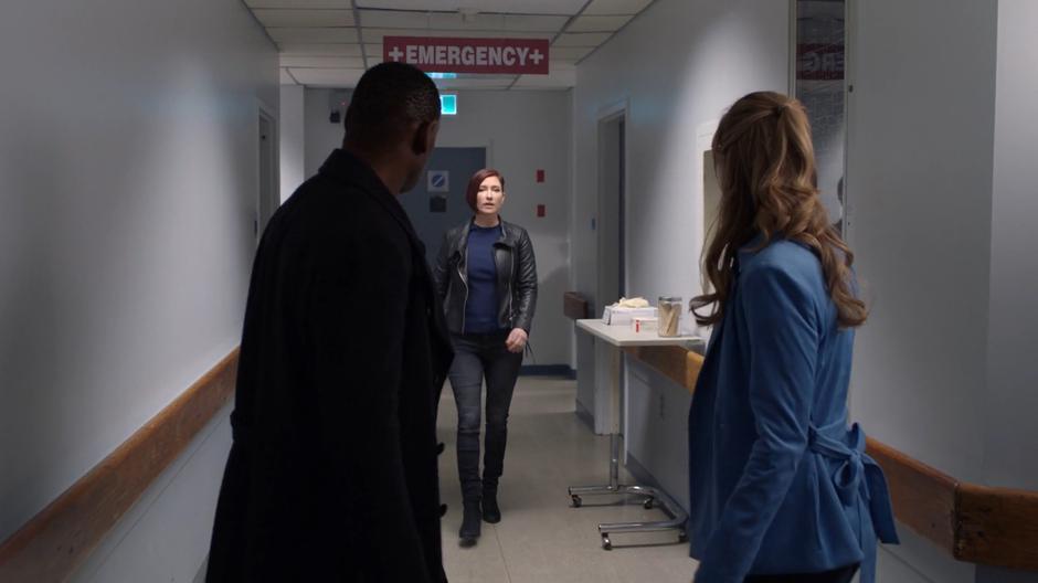 J'onn and Kara turn around as Alex comes down the hallway to talk with them.