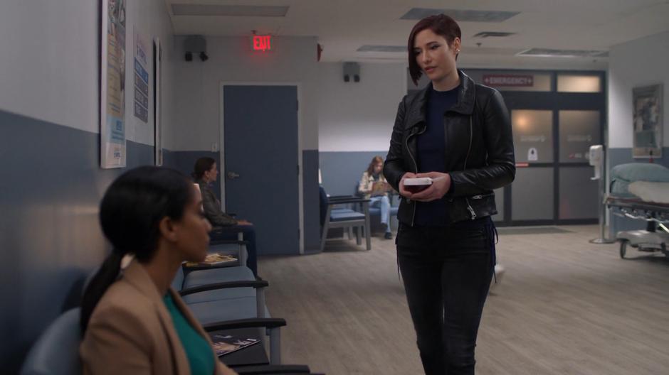 Alex approaches Kelly in the waiting room with a Jell-o peace offering.